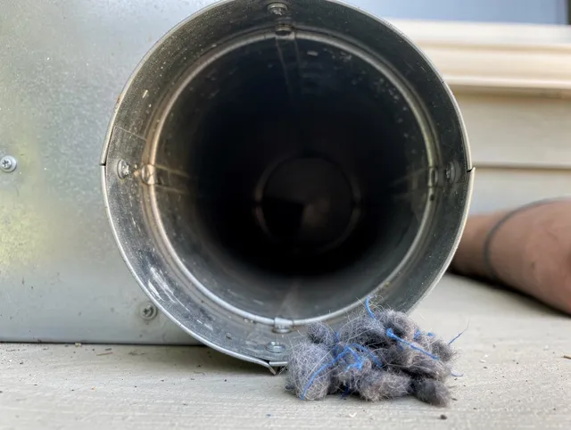 Buena Park Dryer Vent Cleaning technician using specialized equipment to clear severe dryer vent blockage in Buena Park